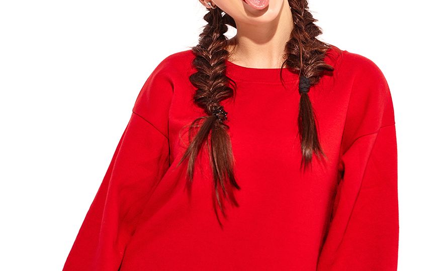young happy smiling woman model with bright makeup and colorful lips with two horns and sunglasses in summer red clothes isolated on white. Going crazy and showing her tongue