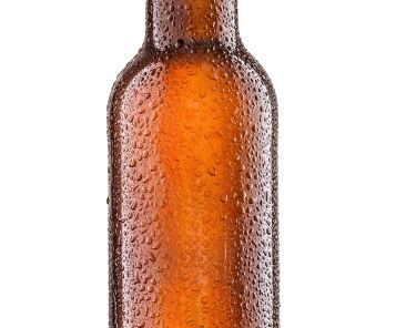 Cold bottle of beer with drops isolated on white background.